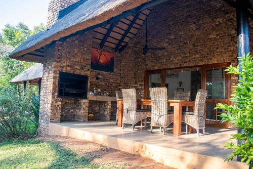 a wooden table and chairs on a patio at Kruger Park Lodge Unit 245 in Hazyview