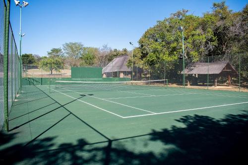 a tennis court with two tennis rackets on it at Kruger Park Lodge Unit 245 in Hazyview