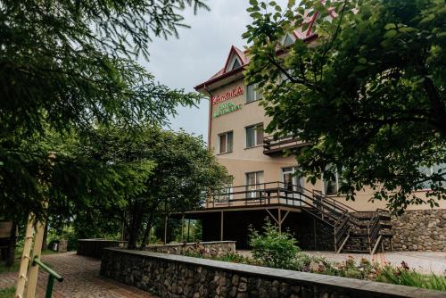 a building with a staircase in front of it at Kamyanka in Mizhhirʼʼya