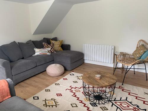 a living room with a couch and a table at Traditional Farm House in the Old Head of Kinsale in Cork
