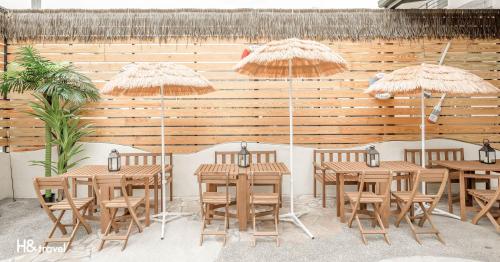 a group of tables and chairs with umbrellas at Taitung Puyuma Style Inn in Taitung City