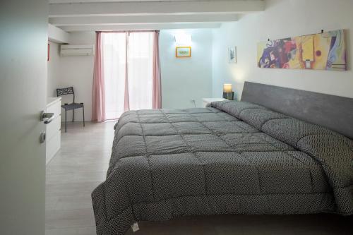 a bedroom with a large bed in a room at Maniace Homes - Federico & Angelica by Ortigia Apartments in Siracusa