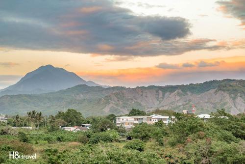 a view of a mountain range with houses and trees at Taitung Puyuma Style Inn in Taitung City