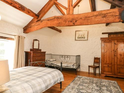 a bedroom with a bed and a dresser at The Barn in Buxton