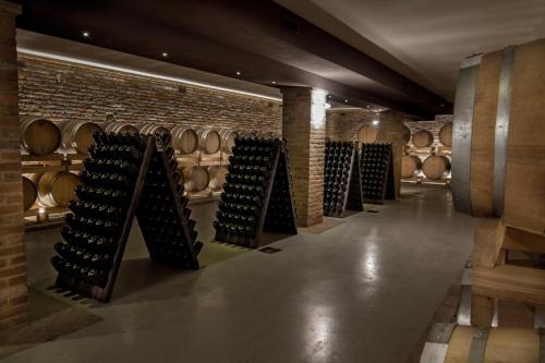 a row of wine racks in a wine cellar at Montalbera Wine Suites in Montemagno