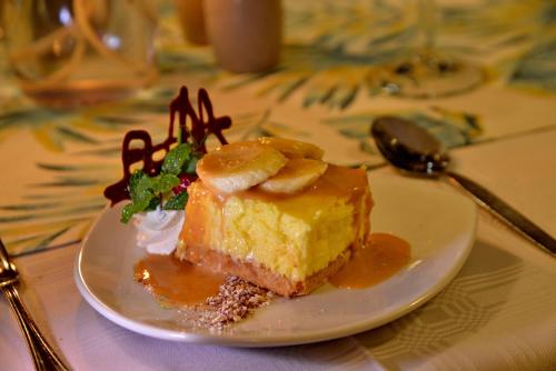 a piece of cake on a plate on a table at Pumula Beach Hotel in Umzumbe