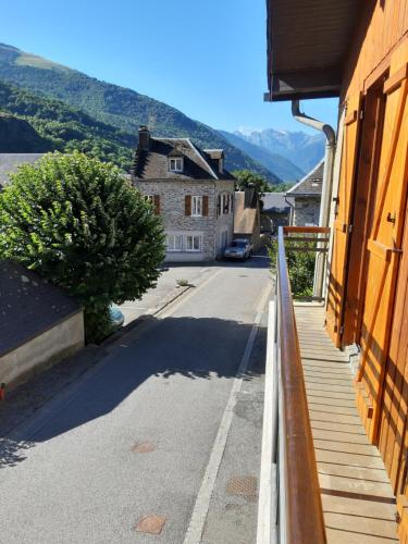 a view of a street from a balcony of a building at Maison des trois ormeaux in Cier-de-Luchon
