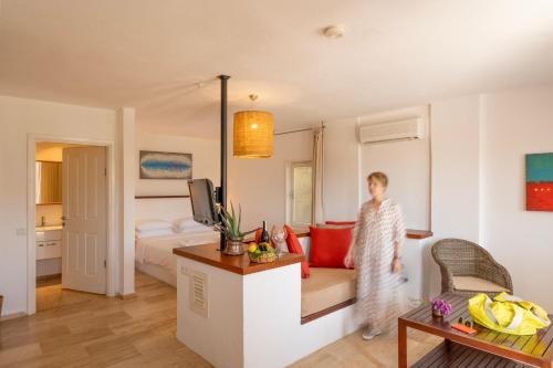 a person standing in a living room with a room at 4reasons hotel + bistro | 12+ in Yalıkavak
