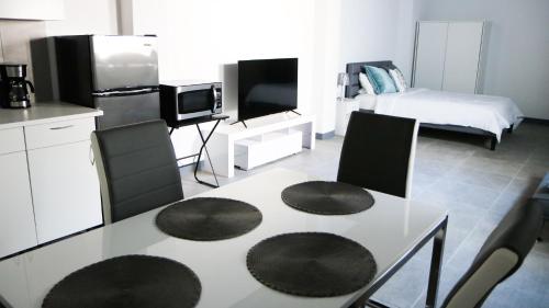 a kitchen with a table with two chairs and a bed at Mavs Boutique At Ponce in Ponce