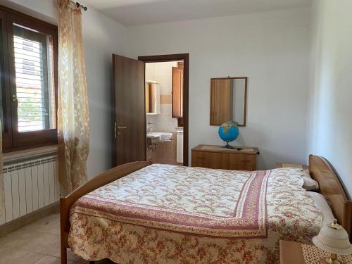a bedroom with a bed and a window at Agriturismo Colle Dei Venti in Arsita