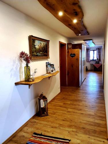 a living room with a wooden floor and a hallway at Haus Matzl inkl. Chiemgaukarte in Ruhpolding