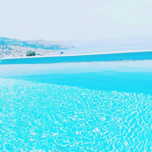 a body of water with a beach in the background at Iliades Luxury Boutique Suites in Batsi