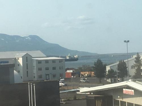 a view of a city with a mountain in the background at Akureyri Lux Apartments with hot tub access in Akureyri