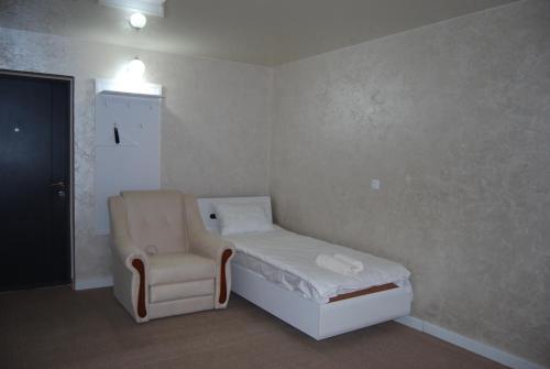 a hospital room with a bed and a chair at DALIM in Duliby