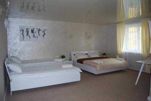 a bedroom with two beds and a window at DALIM in Duliby