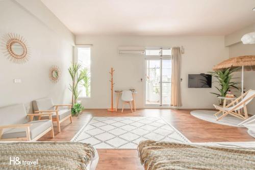 a living room with a couch and a tv at Taitung Puyuma Style Inn in Taitung City