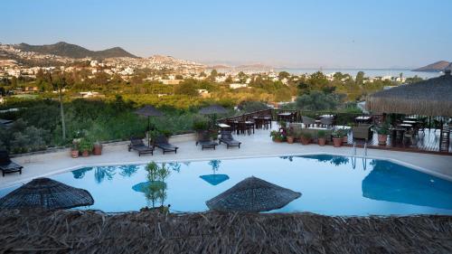 a swimming pool with a view of a resort at 4reasons hotel + bistro | 12+ in Yalıkavak