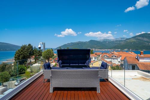 a balcony with a chair on a roof at Elysium Tivat in Tivat