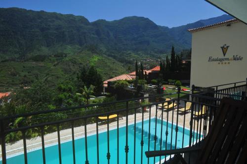 a view from the balcony of a hotel with a swimming pool at Estalagem do Vale in São Vicente