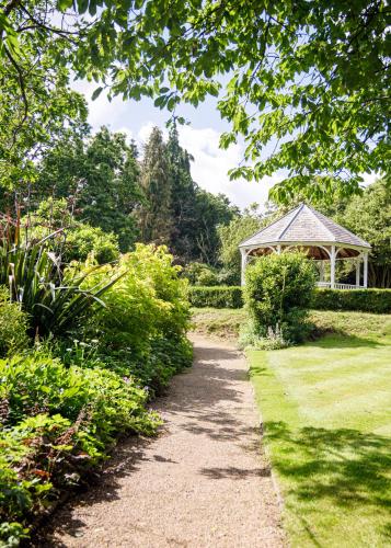 a path leading to a gazebo in a garden at Rowhill Grange Hotel & Utopia Spa in Dartford