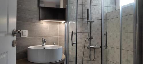 a bathroom with a sink and a glass shower at Harmony House Marathopoli 1 in Marathopoli