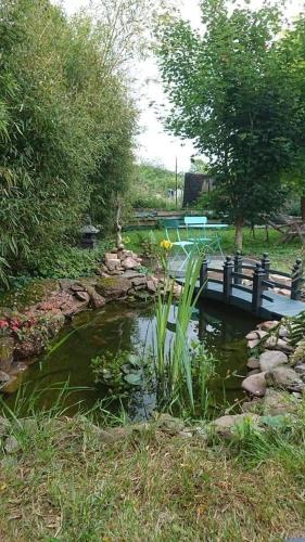 a bridge over a pond with a pond sidx at Gîte Alsace maison indépendante proche Strasbourg in Mutzig