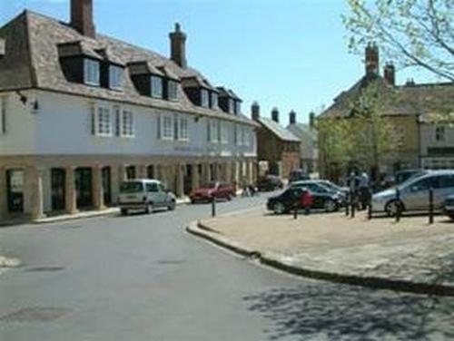 a city street with cars parked in front of buildings at Bramlies Bed & Breakfast in Dorchester