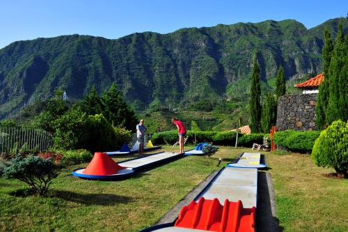 a group of people standing on paddle boards in the grass at Estalagem do Vale in São Vicente