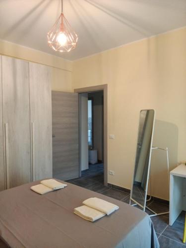 a bedroom with a bed with two towels on it at Casa Renzo in LʼAquila