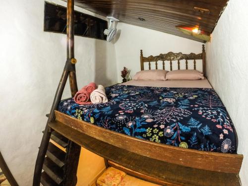a bedroom with a bed in a room with a tripod at Ready Camp e Suítes da Cachoeira in Abraão