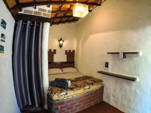 a small bedroom with a bed in a room at Ready Camp e Suítes da Cachoeira in Abraão