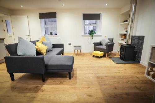 a living room with a couch and a chair at Clifftop Cottage in Arbroath