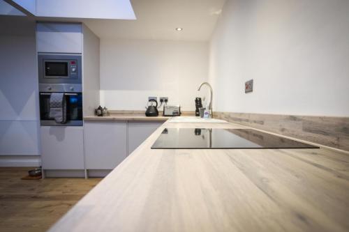 a kitchen with a sink and a counter top at Clifftop Cottage in Arbroath