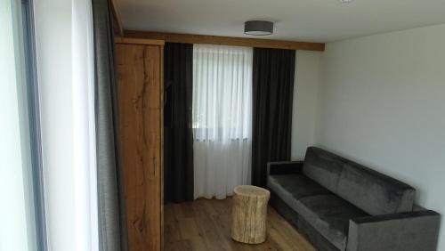 a living room with a couch and a table at Heufelder Hof in Bruckmühl