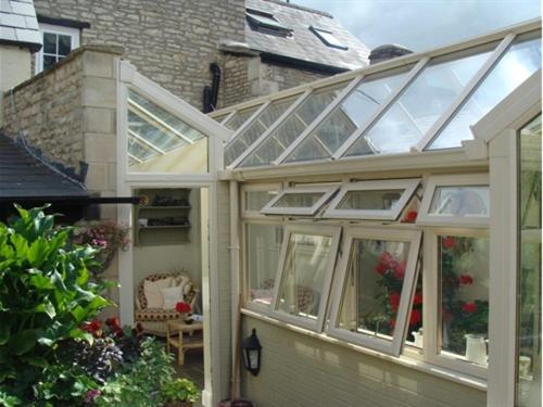 a conservatory with a glass roof on a house at The Old Brewhouse in Cirencester
