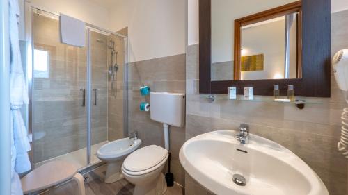 a bathroom with a sink and a toilet and a shower at Hotel San Marco in Reggio Emilia
