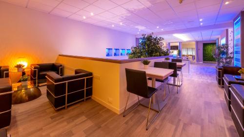 a restaurant with a bar and tables and chairs at Hotel San Marco in Reggio Emilia