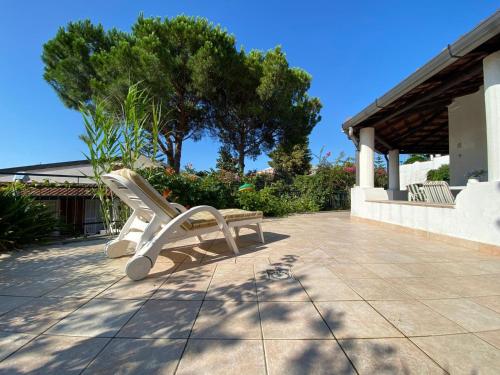 a white bench sitting on top of a patio at Villetta Romeo Casavacanze in Falcone
