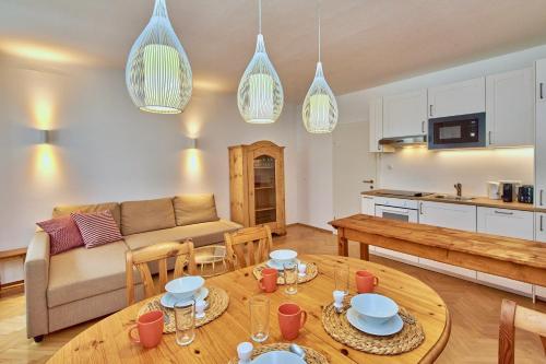 a living room with a couch and a table at Altstadt Apartments Melk mit Sauna in Melk