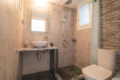 a bathroom with a sink and a toilet at KAMARADO STUDIOS in Kamarai