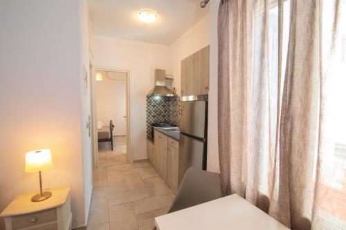 a small kitchen with a table and a window at KAMARADO STUDIOS in Kamarai