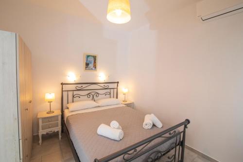 a bedroom with a bed with two towels on it at KAMARADO STUDIOS in Kamarai