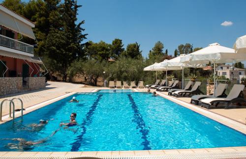 a person swimming in a swimming pool at a hotel at Villa Lilly in Tolo