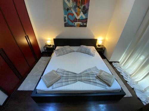 a bed with two bow ties on top of it at Ioannina Luxury Suites & Apartments in Ioannina