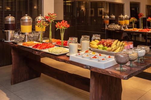 a buffet of food on a table in a restaurant at Faial Prime Suítes in Florianópolis