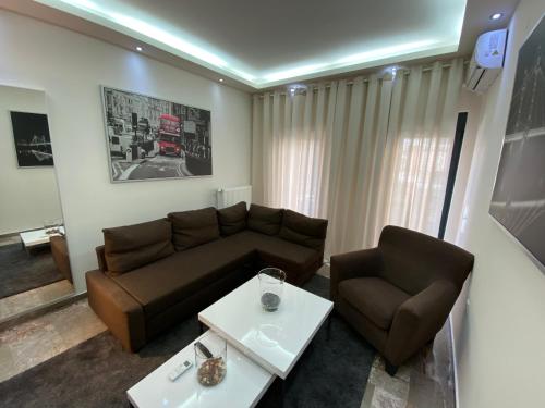 a living room with a couch and a table at Ioannina Luxury Suites & Apartments in Ioannina