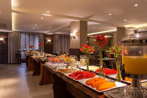 a buffet line with many plates of food at Faial Prime Suítes in Florianópolis