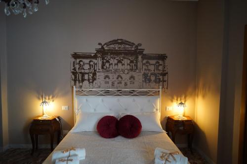 a bedroom with a bed with two red pillows on it at Bari Antica Boutique B&B in Bari