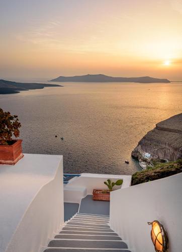 a view of the ocean from a house at Golden Grey Goose in Fira