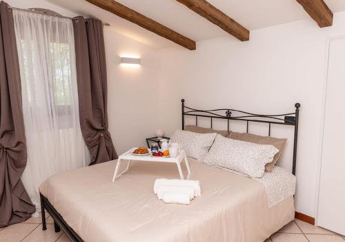 a bedroom with a bed with a tray of food on it at I trulli di Eva in Noci